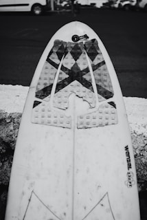 Close-up photo of surfing accessories like leashes and wax on wooden table