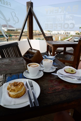 A cozy café table set for two, with pastries and coffee, inviting for a leisurely break.