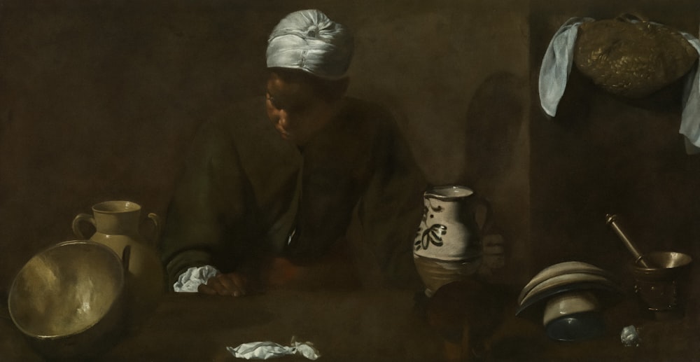 Una pintura de un hombre sentado en una mesa