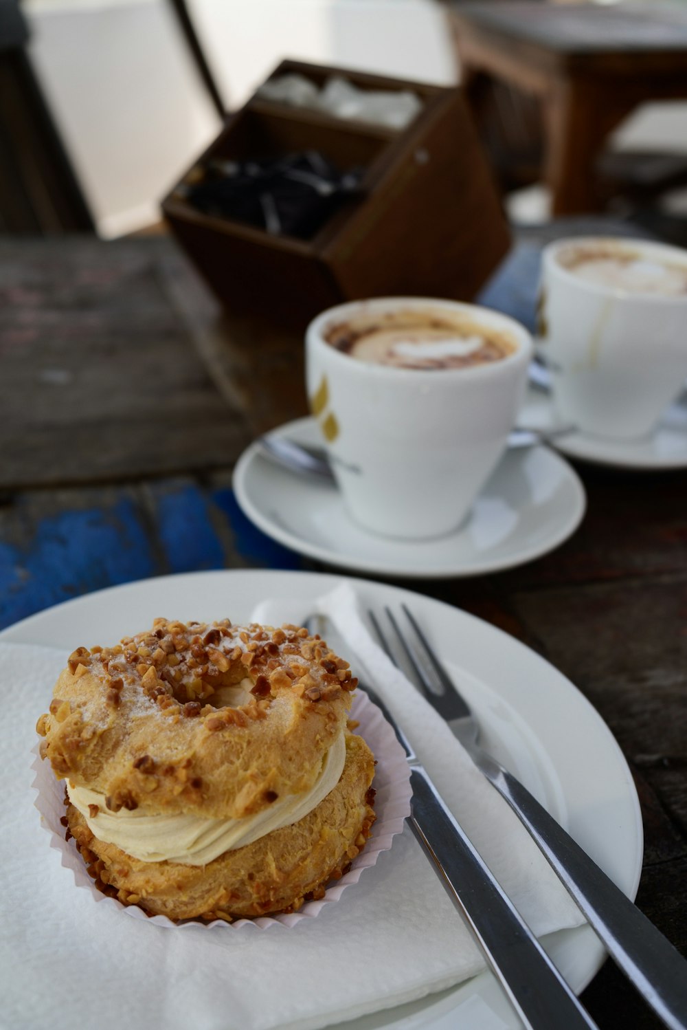 a cup of coffee and a pastry on a plate