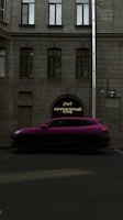 A vibrant purple SUV is parked on a street in front of a building with a gray stone facade. The building features large windows with an archway entrance displaying a neon sign with Cyrillic text. A street sign is also visible on the side of the building.