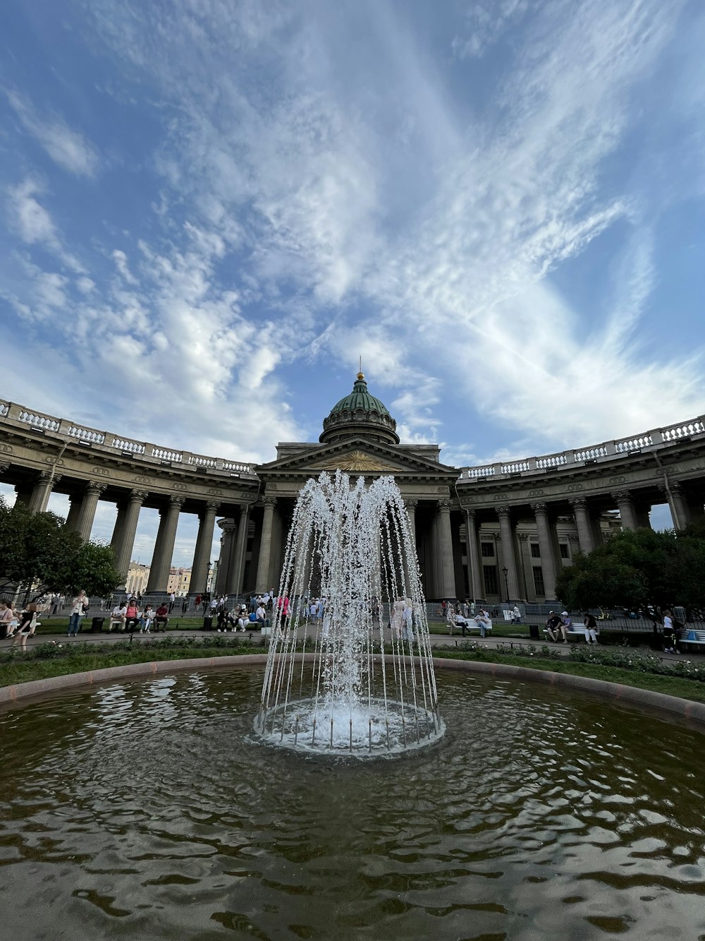 a water fountain in front of a large building