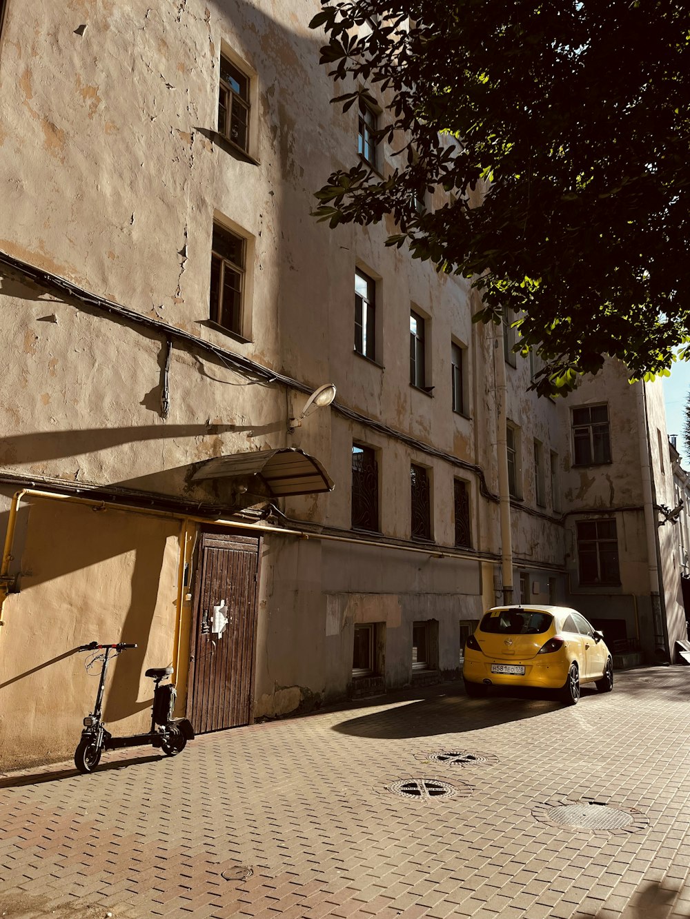 a yellow car parked in front of a building