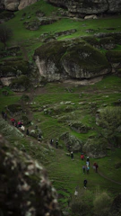 A group walking along a lush green trail with Bekal Fort visible in the distance.