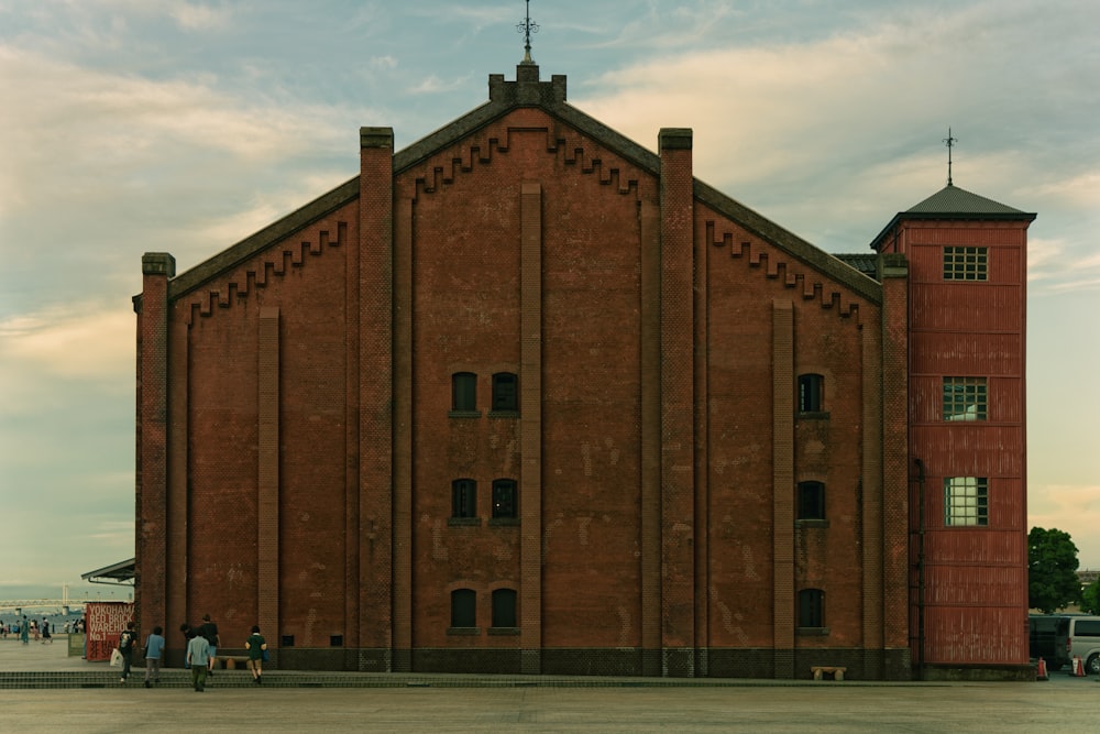 a large red brick building with a clock tower