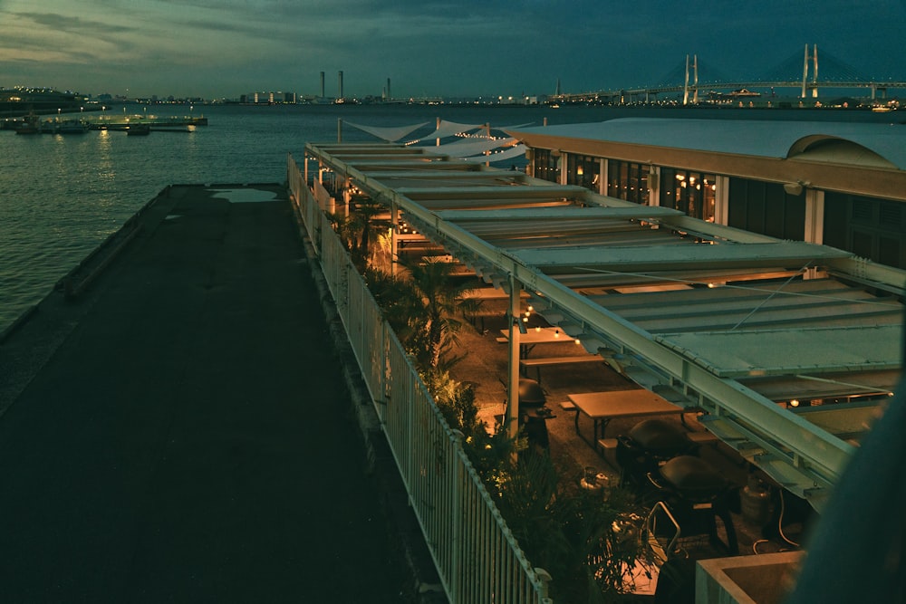 a building next to a body of water at night