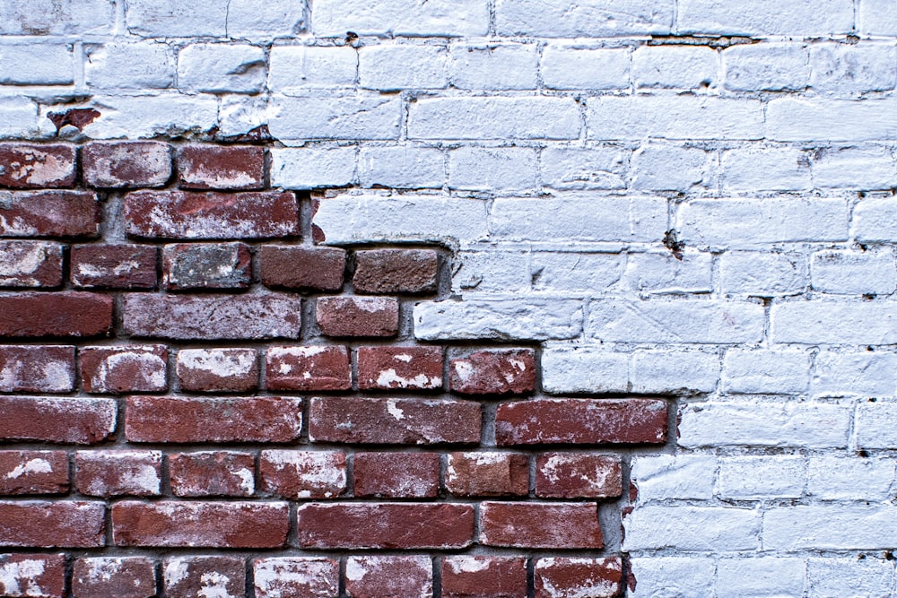 a brick wall that has been painted white and red
