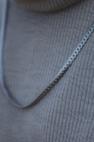 Close-up of a silver necklace chain showing fine details