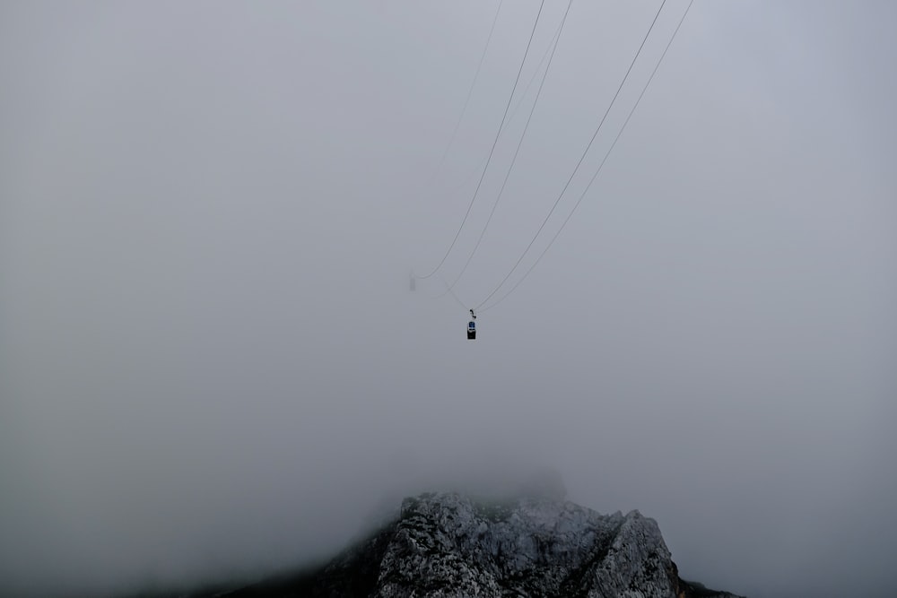 a ski lift in the middle of a foggy mountain
