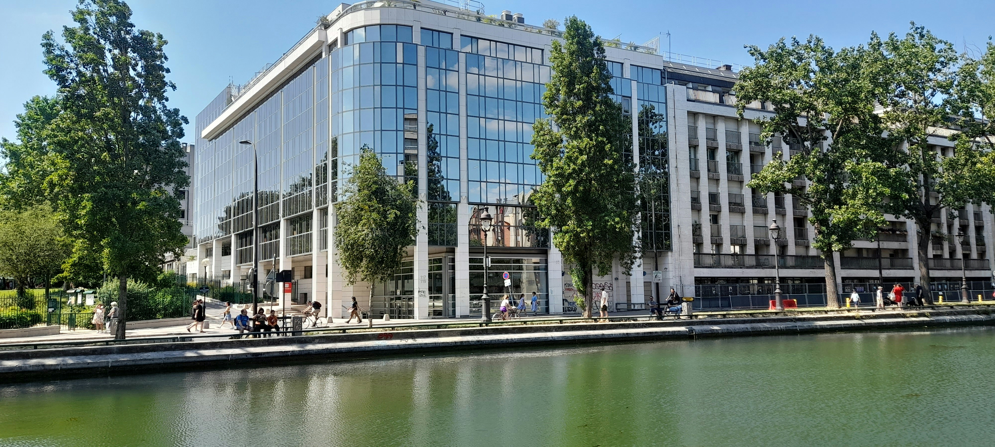 a large building sitting next to a body of water