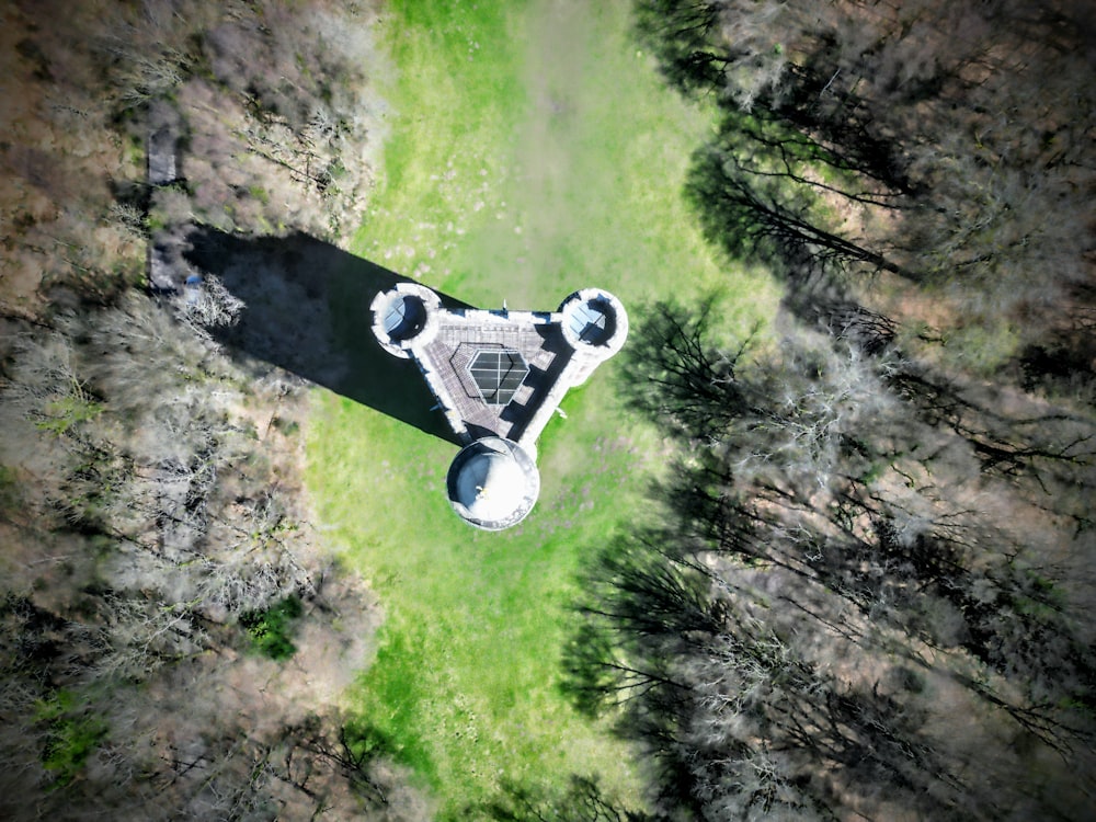 an aerial view of a tower in the middle of a forest