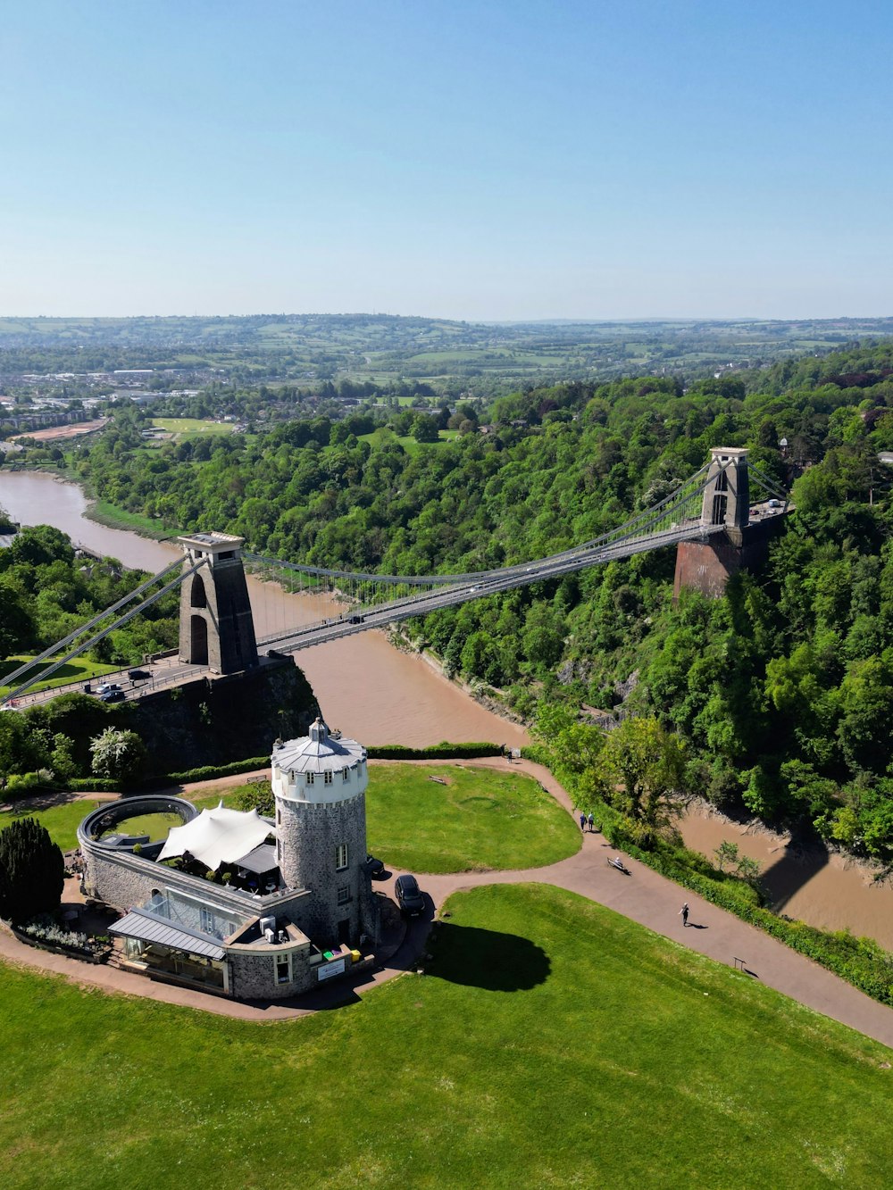 an aerial view of a castle with a bridge in the background