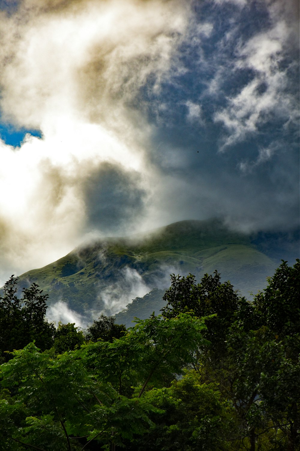 a view of a mountain with clouds in the sky