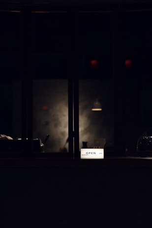 A close-up of a slim, illuminated lightbox display glowing softly in a modern retail setting.