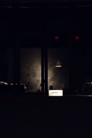 A sleek, ultra-slim lightbox display glowing softly in a chic retail boutique.