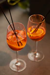 a couple of glasses filled with drinks on top of a table