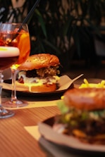Top view of a crispy onion burger with melted cheddar cheese on a wooden table.