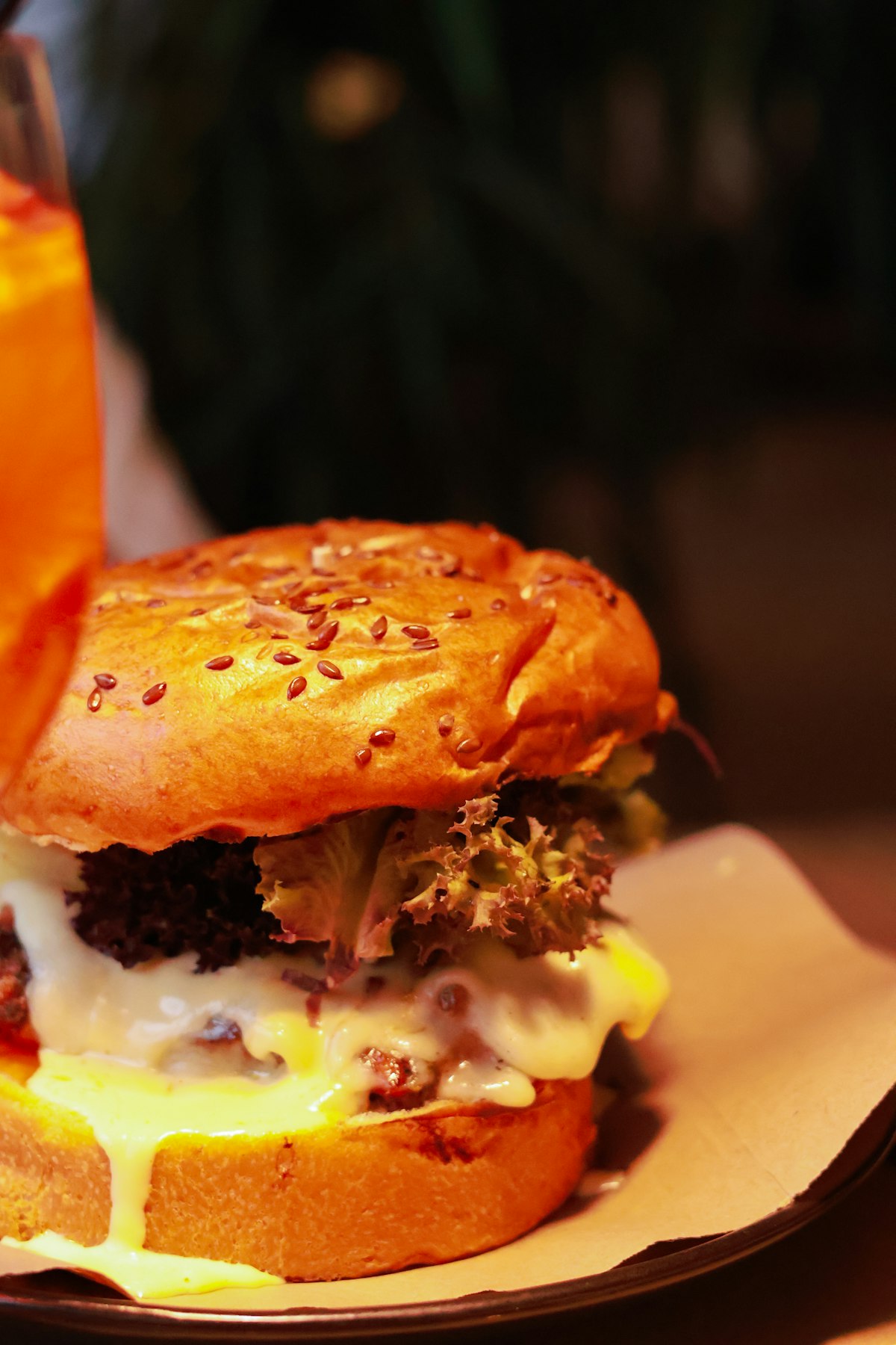 Cheeseburger and soft drink on a plate, ultra-processed-food shorthand