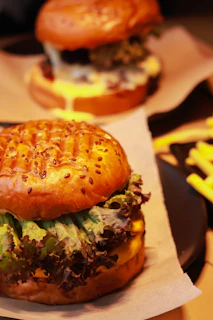 A vibrant close-up of a loaded shamrock-themed burger with fresh lettuce, tomato, and melted cheese.