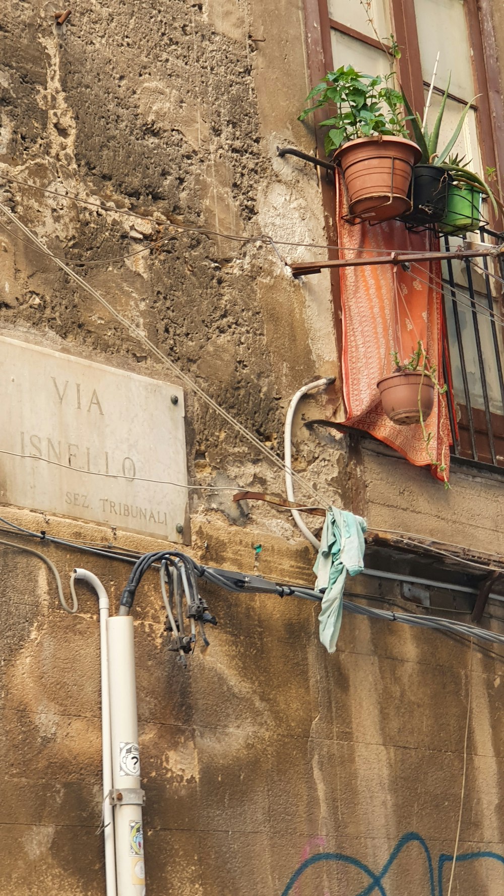 a building with a window and a sign attached to it