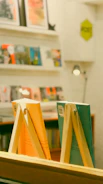 A blurred background of warm-toned bookshelves filled with novels and soft lighting.