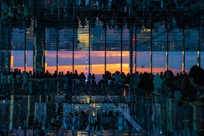 A panoramic view of a diverse group attending a live seminar in a sleek, contemporary observatory setting.