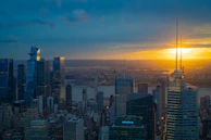 Panoramic view of a high-rise building with large insulated glass panels glowing in sunset light.