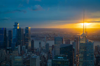 A panoramic view of a sleek, modern land development site under a golden sunset.