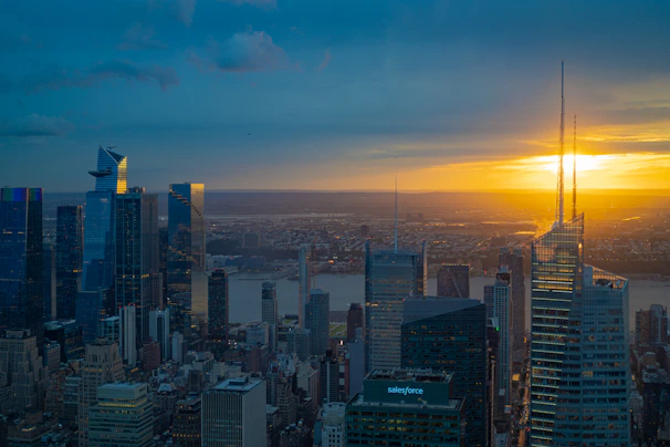 A panoramic view of a sleek, modern land development site under a golden sunset.
