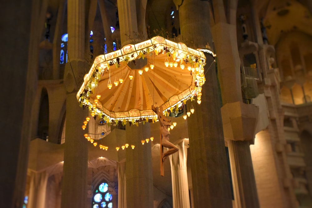 a light up umbrella hanging from the ceiling of a building