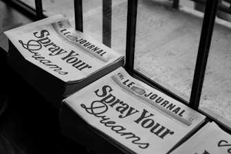 a couple of newspapers sitting on top of a wooden table