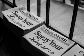 a couple of newspapers sitting on top of a wooden table