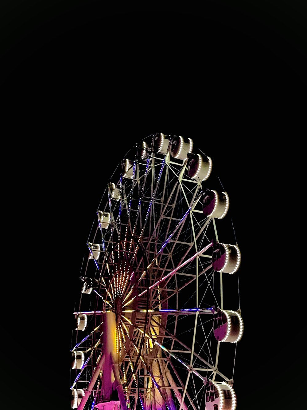 a ferris wheel lit up in the night sky