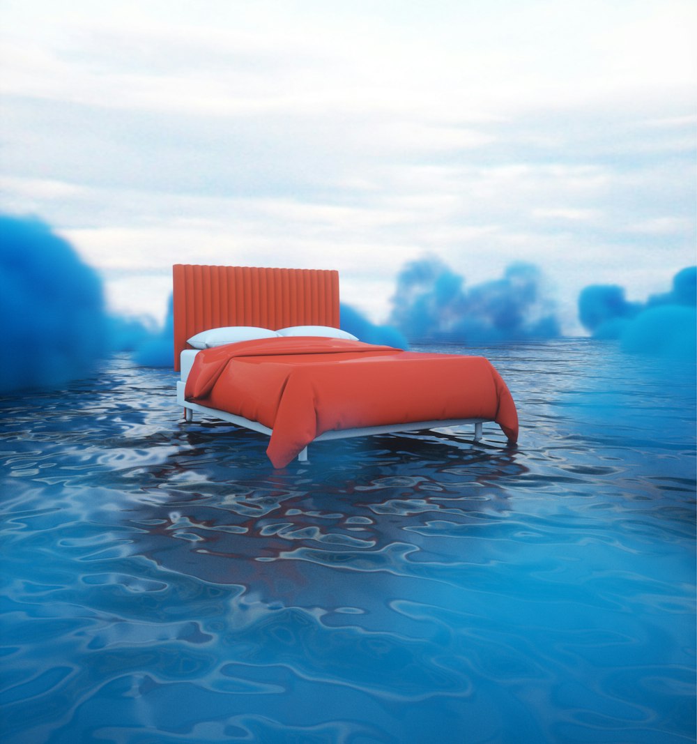 a bed sitting in the middle of a body of water