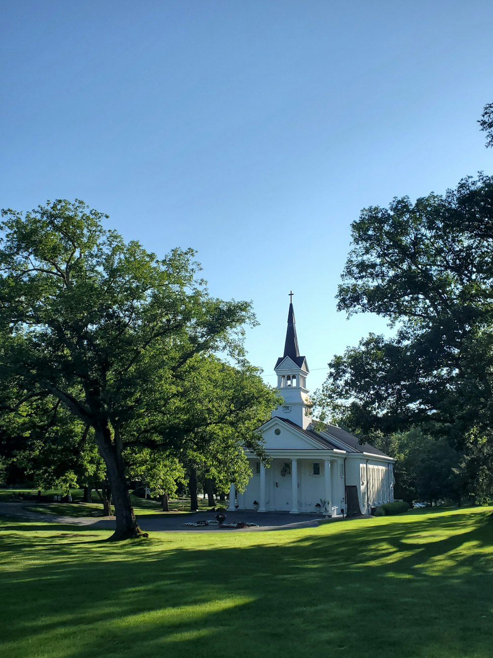 a white church with a steeple and a steeple on top of it