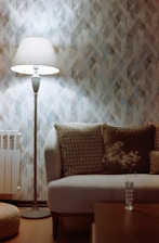 A cozy living room illuminated by stylish floor lamps and soft ambient lighting.
