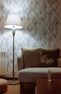 Cozy living room corner with stylish floor lamp and cushions