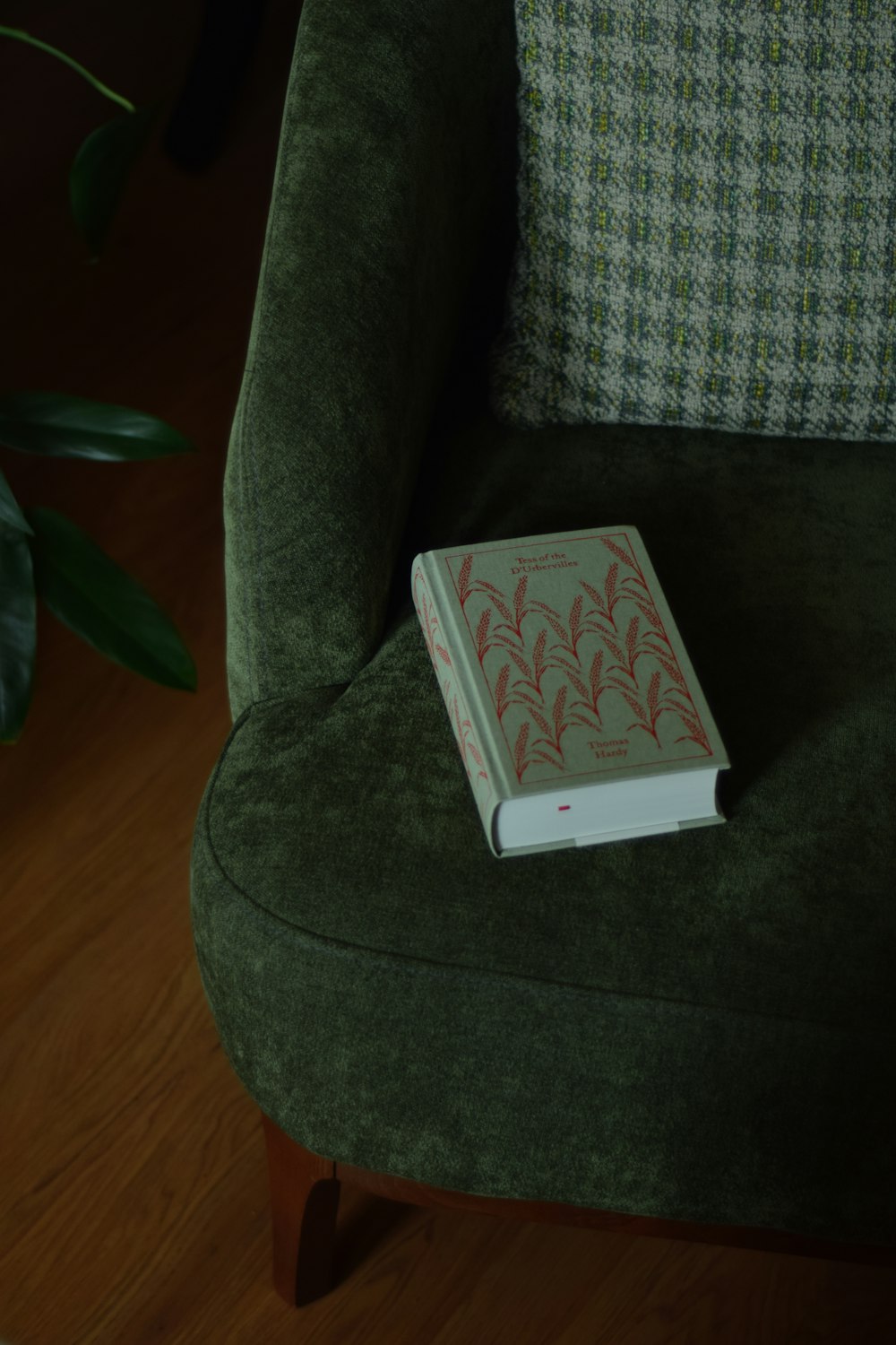 a book sitting on top of a green chair