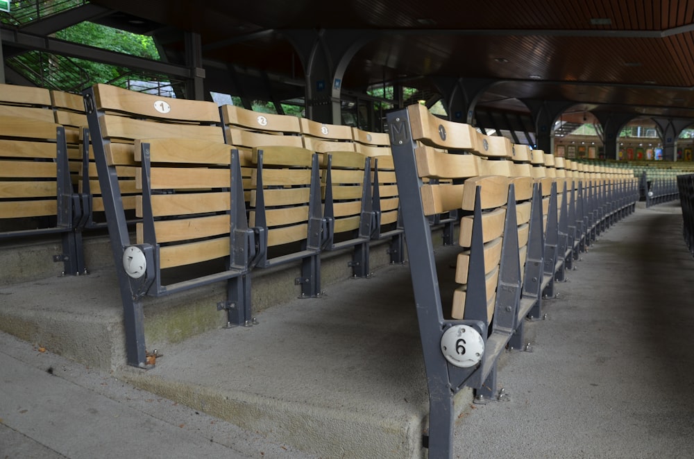a row of wooden seats sitting next to each other