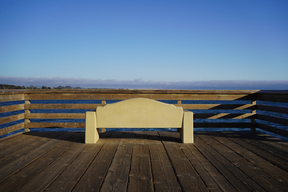 a bench sitting on top of a wooden deck