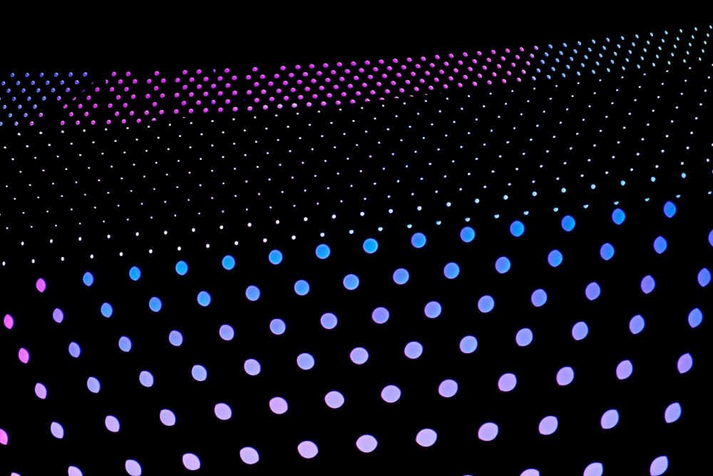 a black background with purple and blue dots