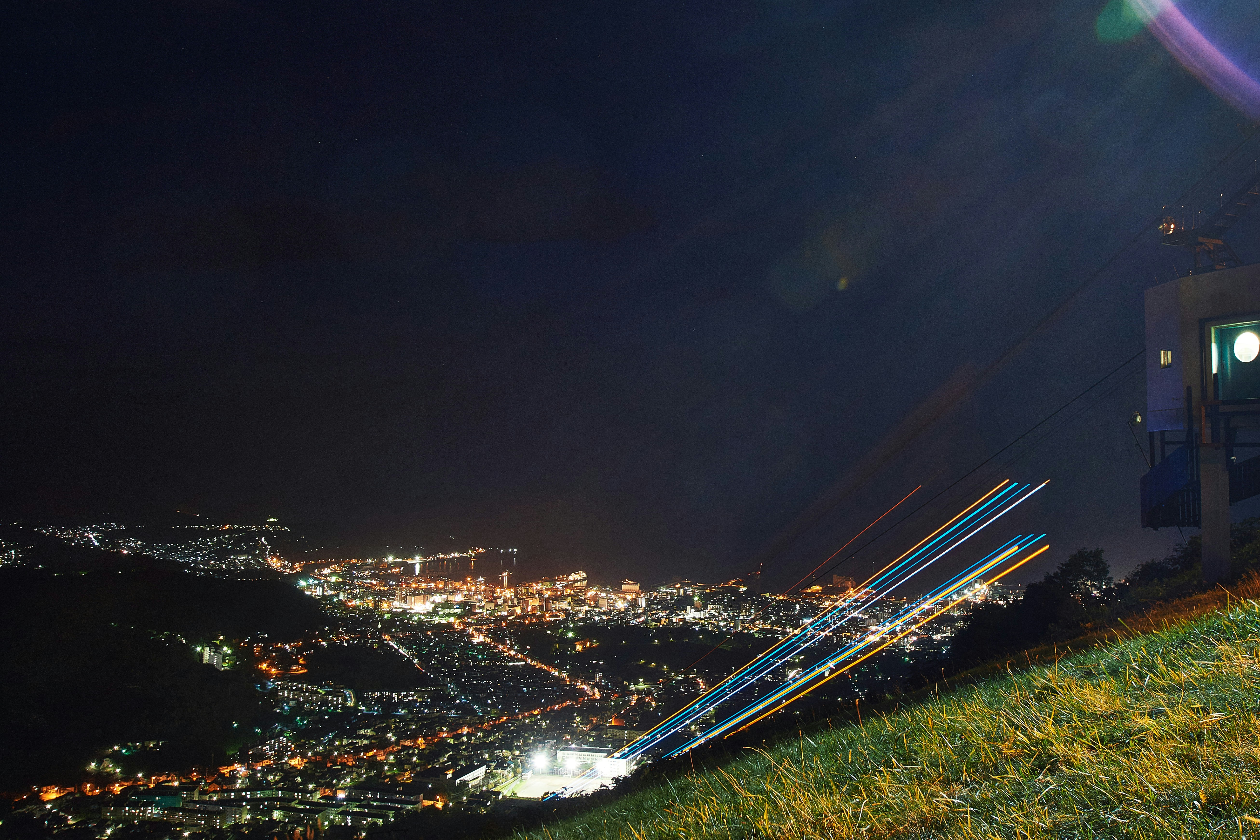 A view of a city at night from a hill photo – Free Hokkaido Image on ...