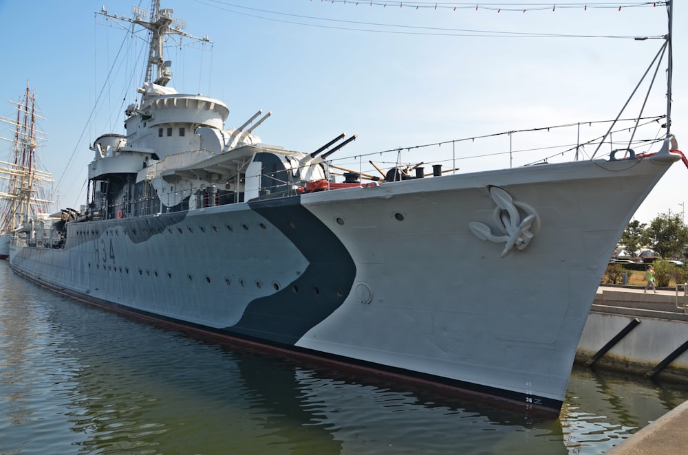 a large white ship docked at a dock