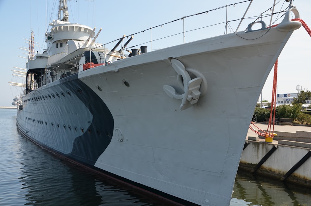 a large white boat docked at a dock