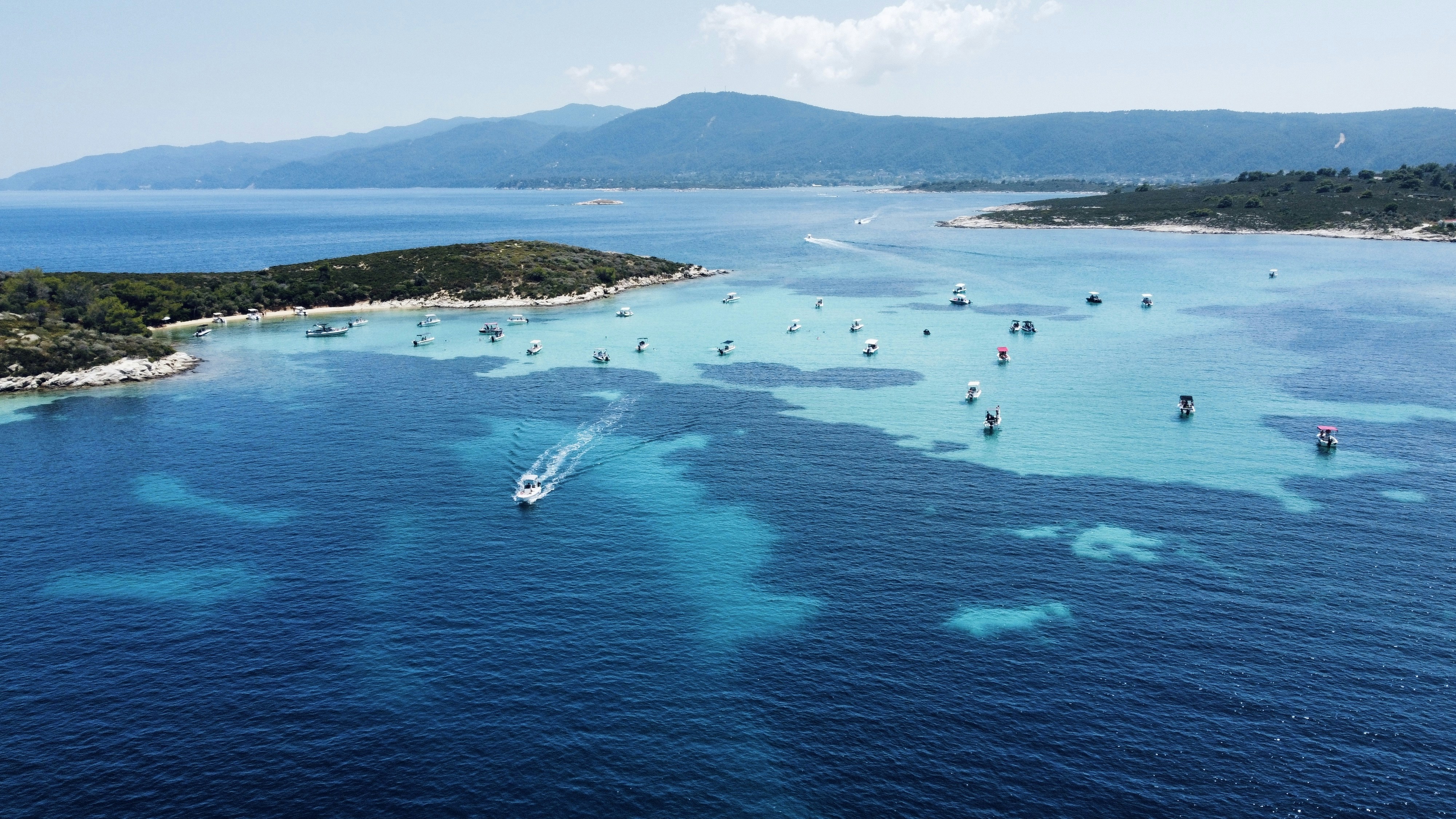a group of boats floating on top of a large body of water