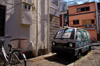 a van parked on the side of a street next to a bike