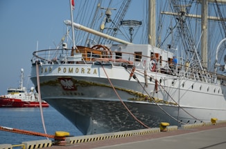 a large white boat docked at a pier