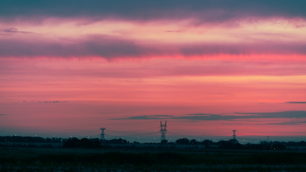 the sky is pink and purple as the sun sets