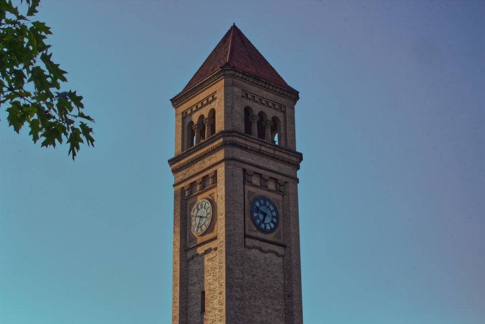 a tall clock tower with a clock on each of it's sides