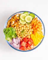 A vibrant salad bowl with crisp greens, tomatoes, and cucumbers, perfect for a light lunch.